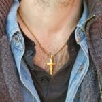 Gold cross necklace worn